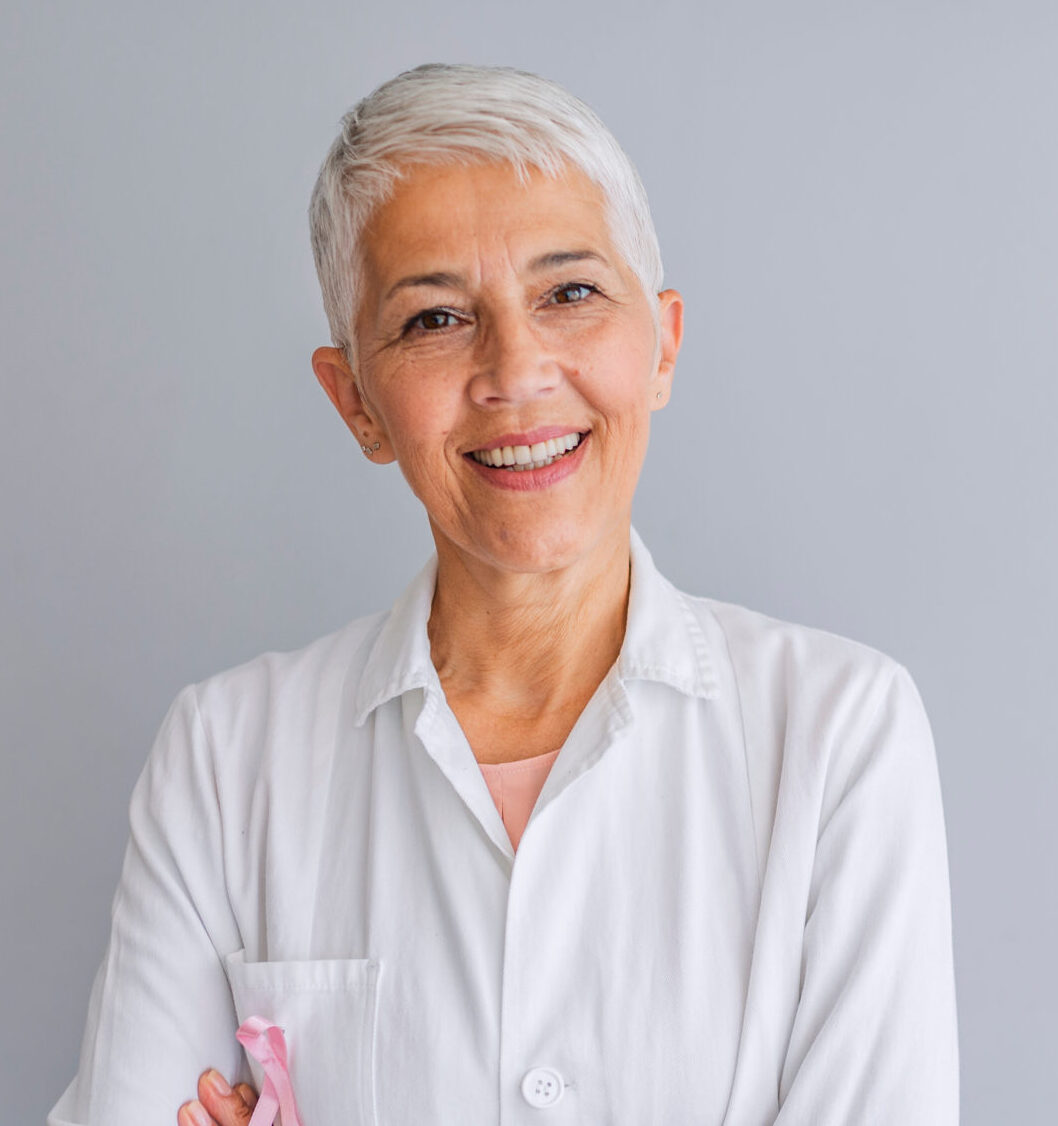 Senior female doctor. Woman doctor smiling and looking to the camera. Portrait of beautiful mature female doctor looking at camera. Beautiful female doctor. Medical concept